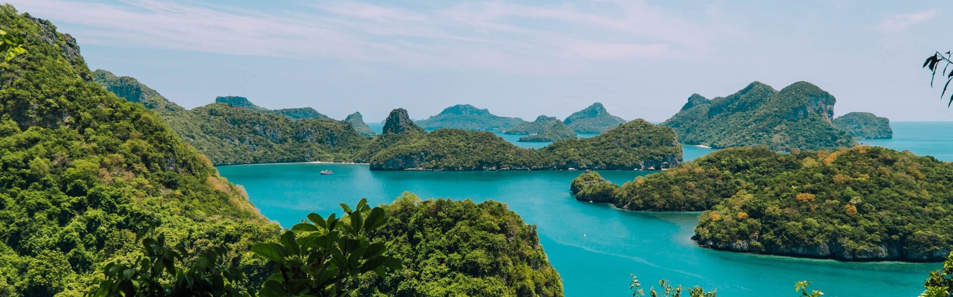 Crystal waters and limestone cliffs in Ang Thong for an Ang Thong Tours banner with Legend Travel Group.
